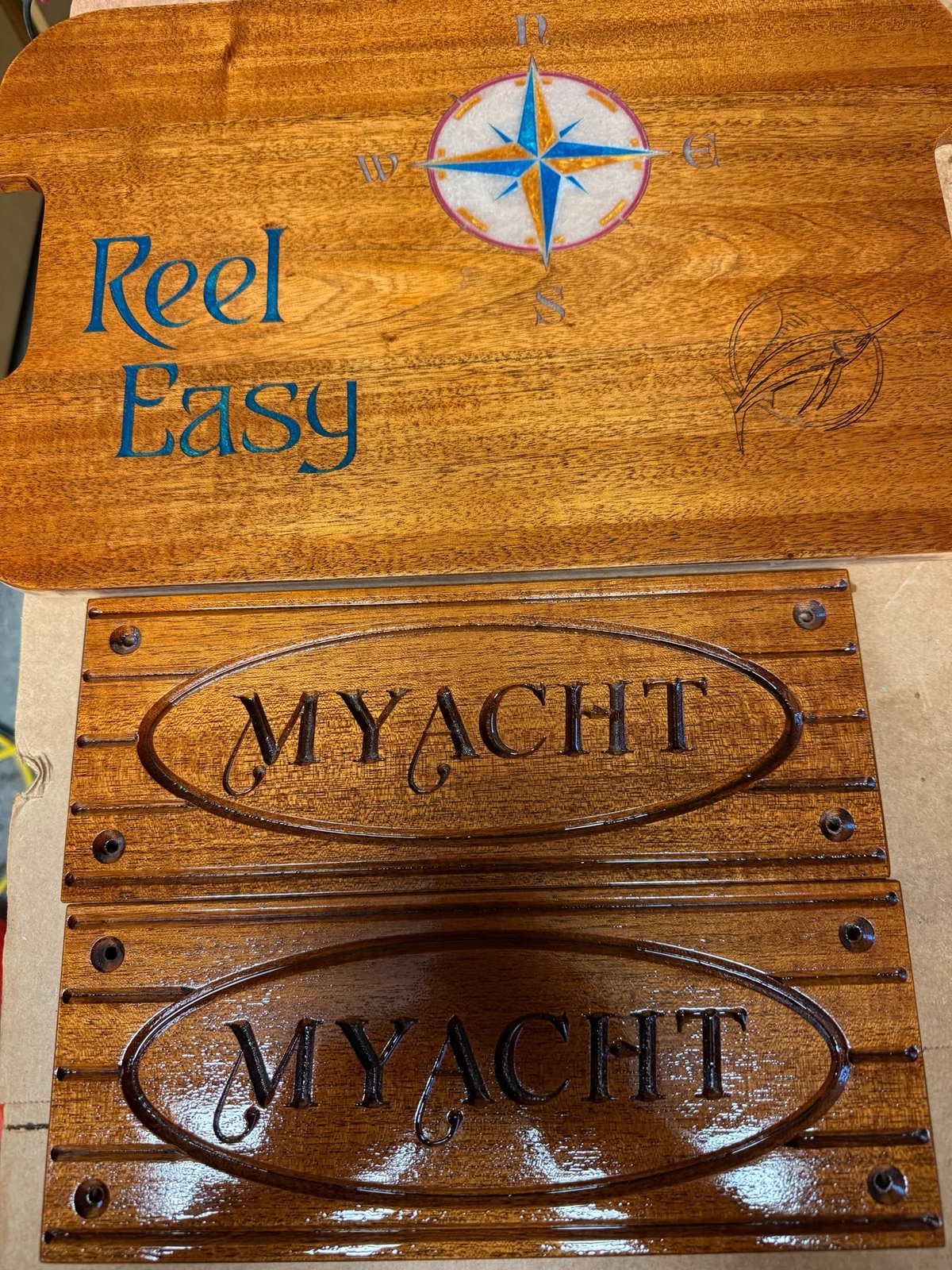 Personalized wood signs with compass and fishing designs