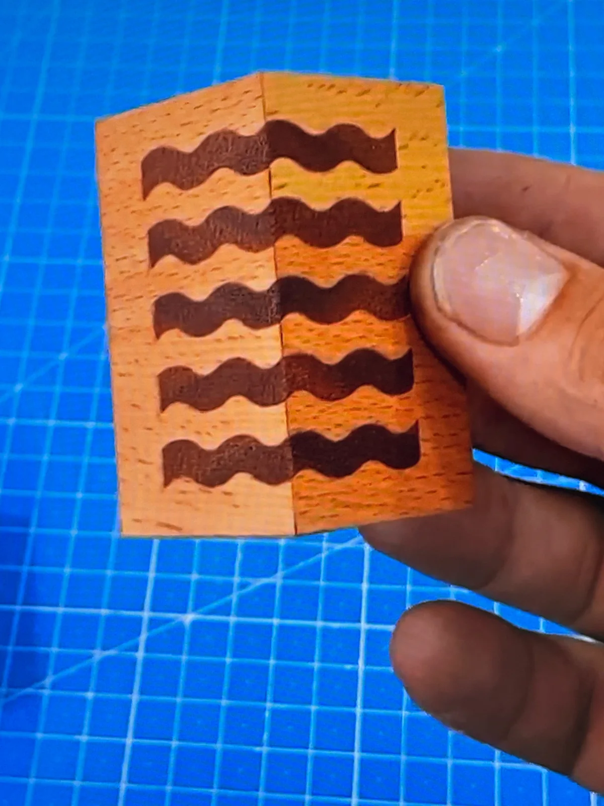 Small custom wood joinery detail in a maker's hand